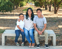 A person and two boys sitting on a bench
AI-generated content may be incorrect.
