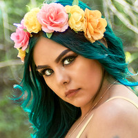 A person with flowers in her hair
AI-generated content may be incorrect.